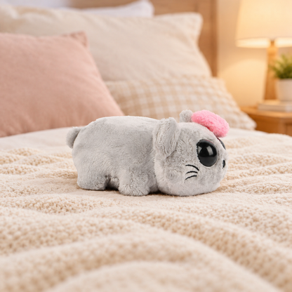 Sad Hamster 5.9 inches (15 cm) plush with a pink bow lying on a cozy bed